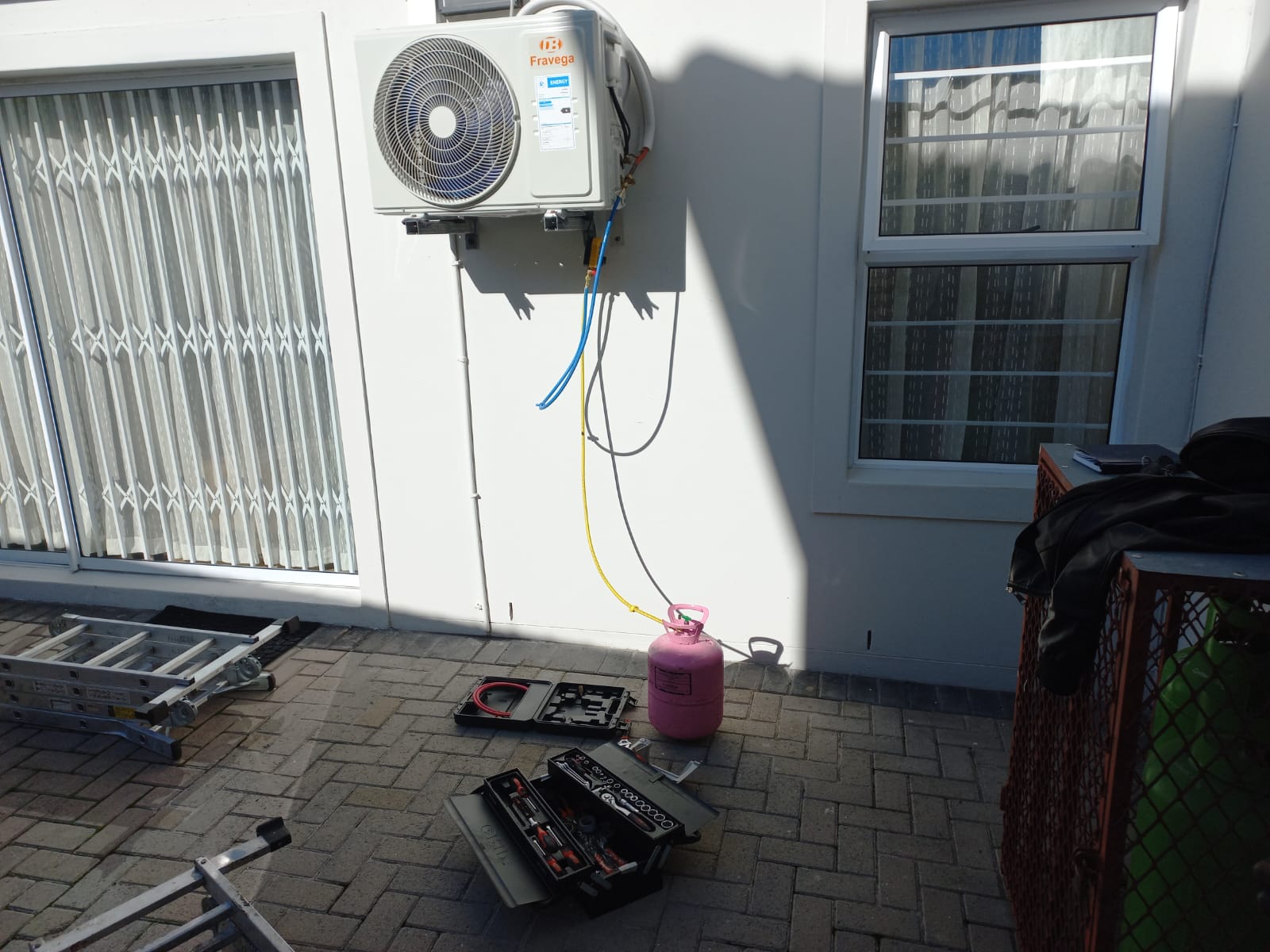 Air conditioning outdoor unit being serviced